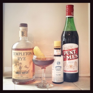A Manhattan made with Punt e Mes vermouth and lemon rind garnish